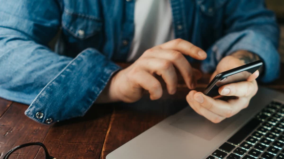 Person on phone erasing messages as evidence.
