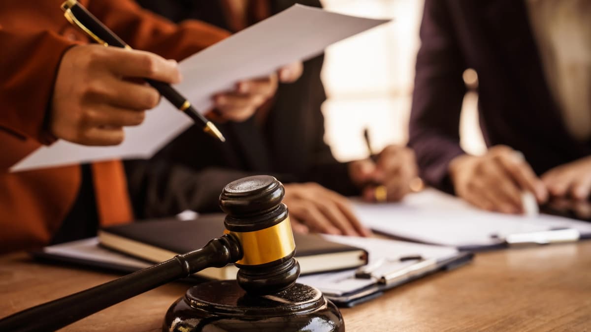 Lawyer and their client signing court documents.